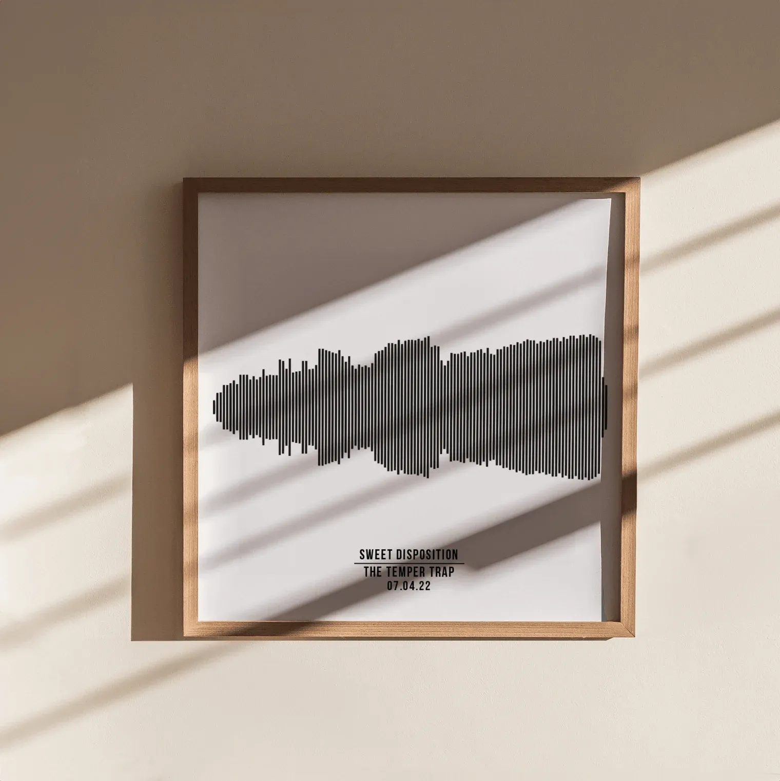 Silver metallic foil print with custom text and circular design framed in black, surrounded by plants