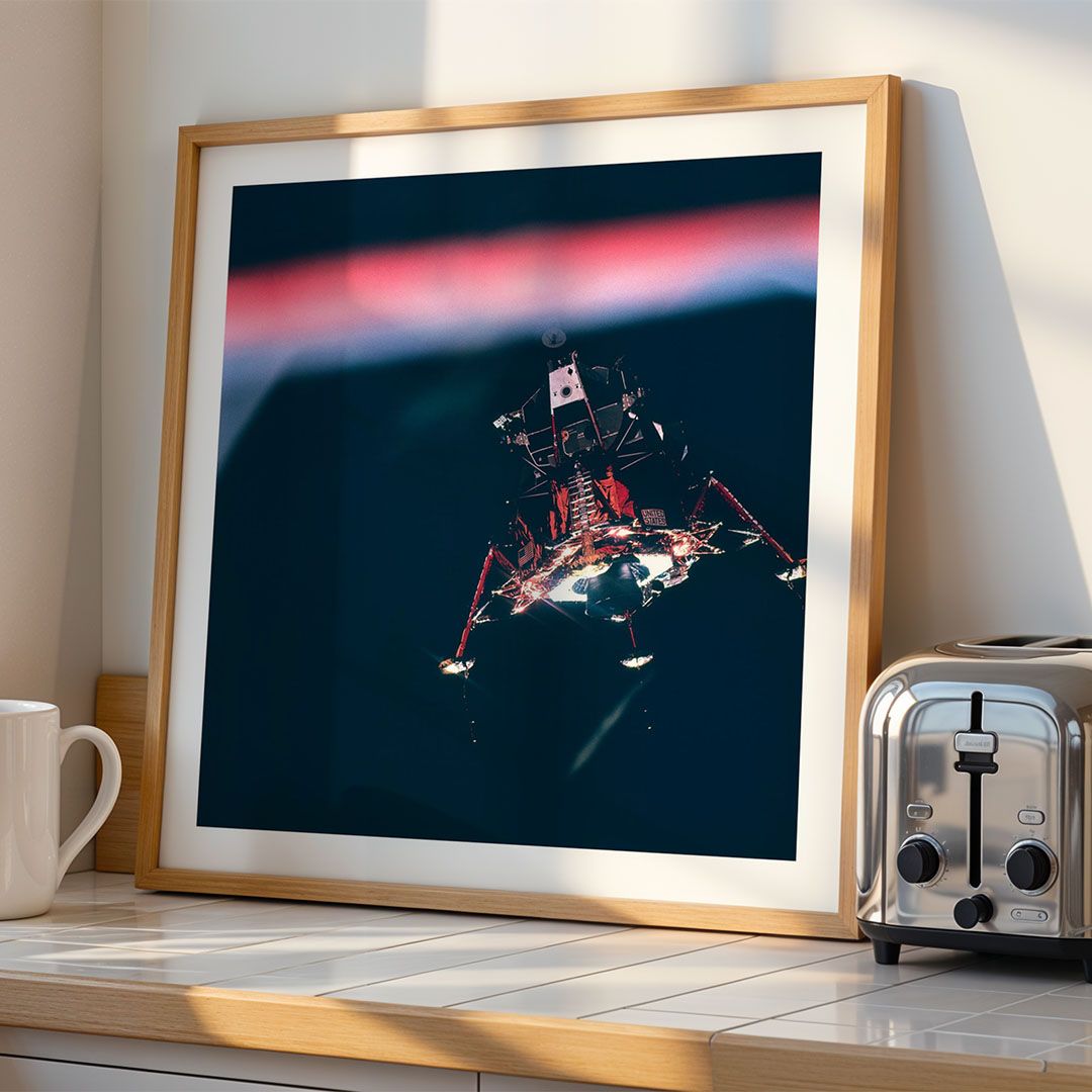 Framed poster mockup in a kitchen setting generated from uploaded artwork